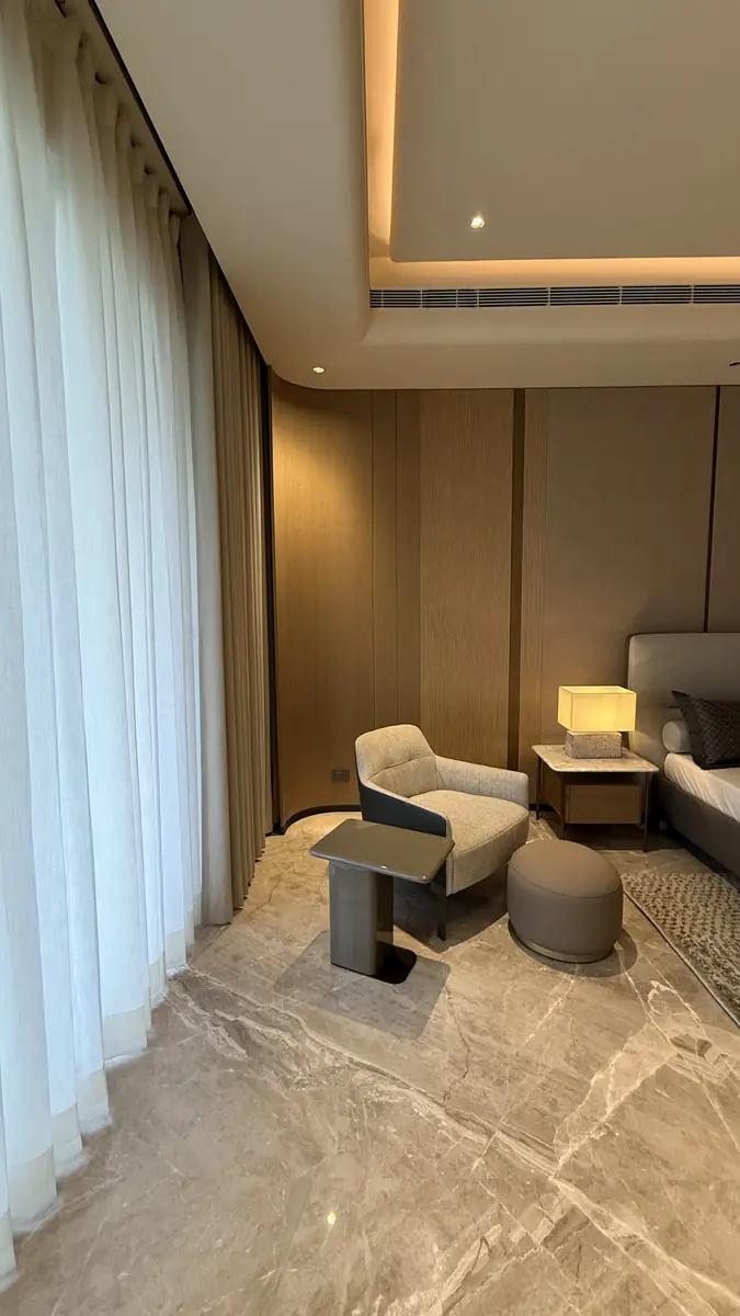 Sheer curtains and a lounge chair in a Gurgaon residence