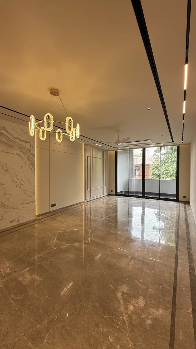 Reception room with balcony glazing and marble flooring in a builder floor in Gurgaon