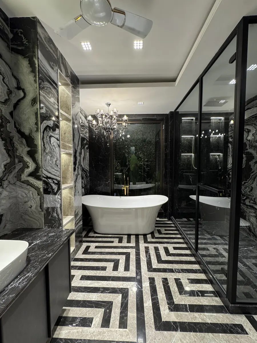 Principal bathroom with a freestanding bath and patterned marble floor in Gurgaon