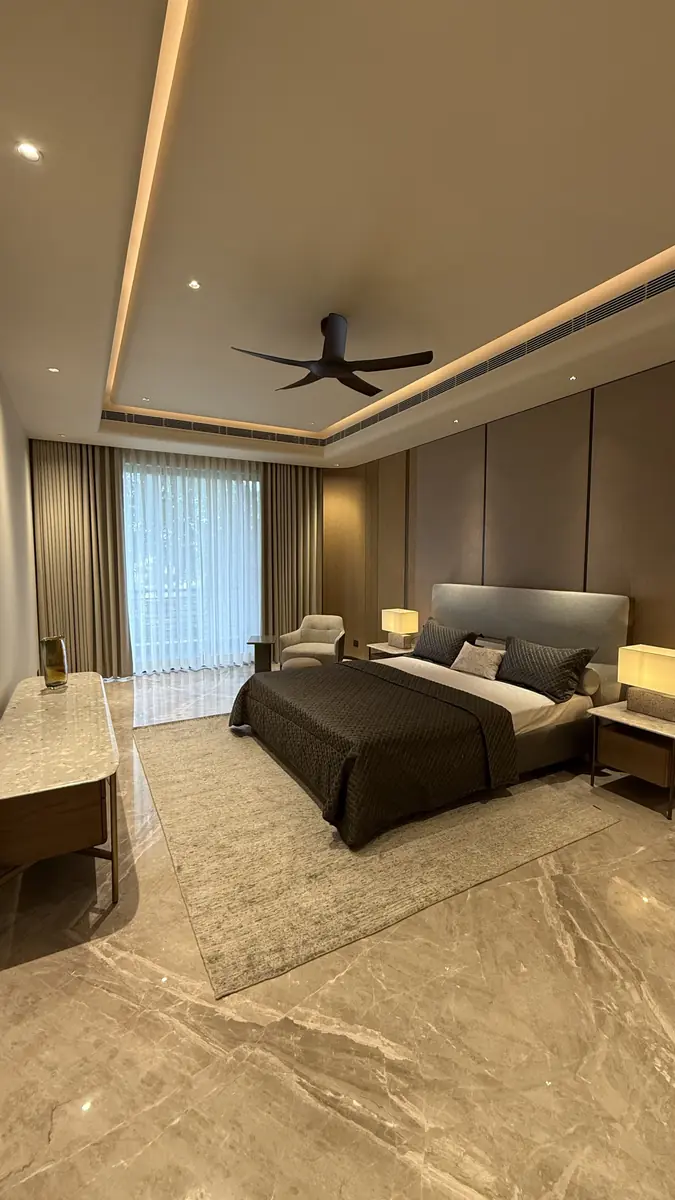 Bedroom with curtained window wall in a luxury builder floor in Gurgaon